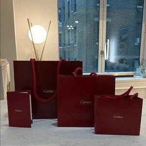 Cartier Red Luxury Bags with Gold Detailing